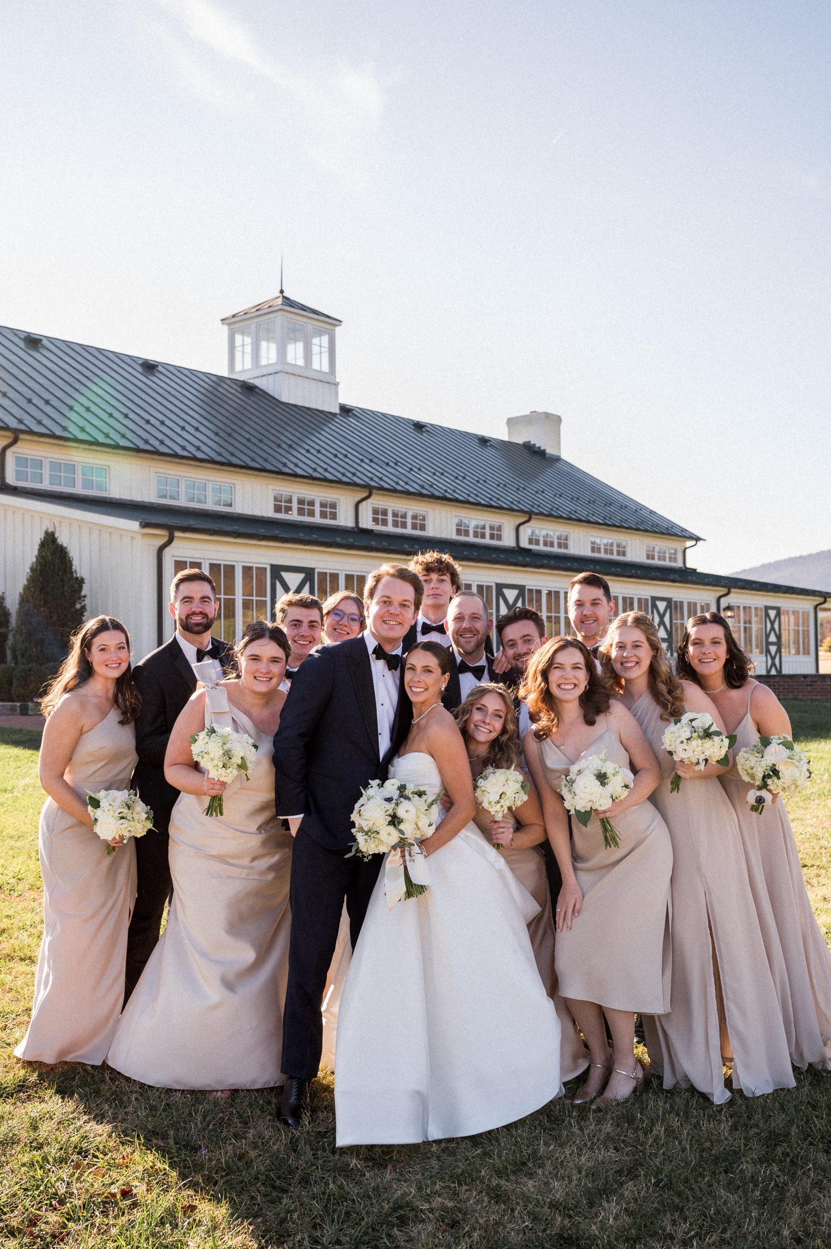 Claire and Jake surrounded by family at their vineyard wedding, with a refreshing open view.