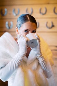 Claire posing gracefully in her strapless wedding gown and veil, showcasing her timeless bridal style.
