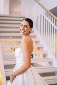 Charlottesville wedding makeup artist applying soft glam makeup and creating an elegant updo for the bride before the ceremony.
