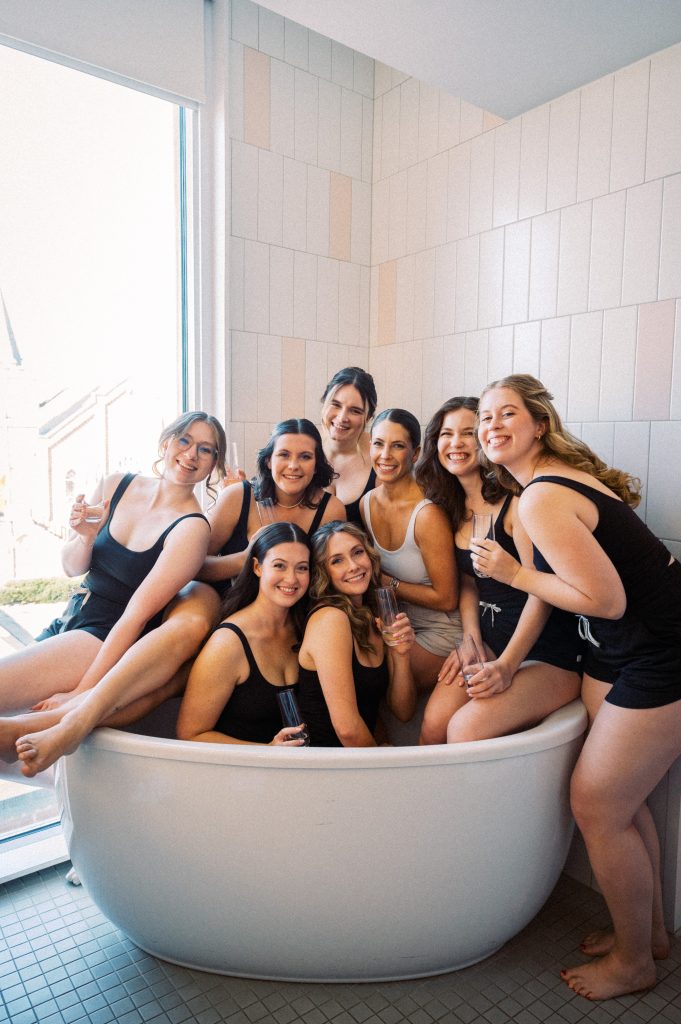 Claire laughing with her bridesmaids while getting ready for her fall vineyard wedding at King Family Vineyards.